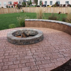 Mayan Cobblestone Patio with Unilock Firepit and Seat Wall